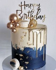 a birthday cake with gold and blue icing