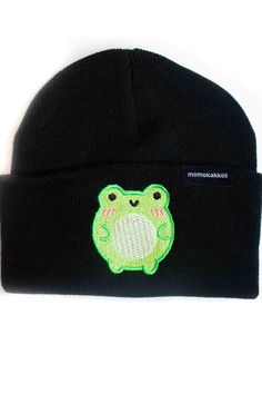 a black beanie with a green frog embroidered on it