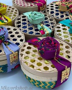 many different colored baskets with ribbons on them