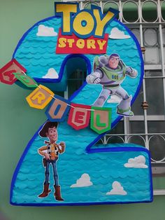 the number five sign for toy story is decorated with cartoon characters, including buzz and woody