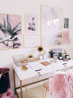 a white desk topped with lots of pink and gold furniture next to pictures on the wall