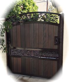 a wooden gate with iron work on it