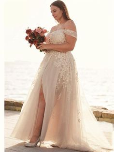 a woman in a wedding dress holding flowers