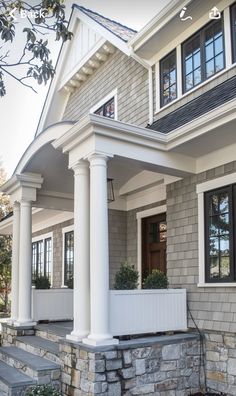 a house with white columns and black shutters