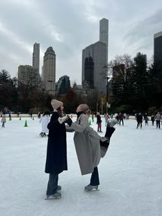 two people standing on an ice rink in the city