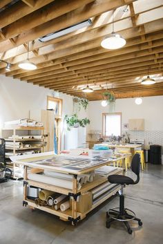 a room filled with lots of different types of furniture and lighting fixture hanging from the ceiling