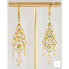 You will look so pretty in these Pink Glass Filigree Drop Earrings! Enhance your beauty with these Pink Glass Filigree Earrings! Sweet and elegant these stunning earrings are a must-have for any wardrobe, featuring lovely faceted pink briolette glass beads, micro-faceted white glass beads, and gold seed beads. The gold-plated filigree and lever backs add a touch of elegance to these 2.75 inch long earrings. Perfect for adding a touch of romance and charm to your look, these gold filigree dangle Pink Elegant Beaded Earrings For Celebration, Elegant Pink Beaded Earrings For Celebration, Elegant Handmade Gold Crystal Earrings, Delicate Gold Chandelier Earrings For Party, Elegant Gold Beaded Earrings, Gold Beaded Bridal Earrings For Celebration, Gold Delicate Crystal Earrings For Party, Elegant Earrings With Gold Beads, Delicate Gold Crystal Earrings For Party