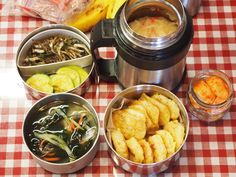 there are many different types of food in bowls on this tableclothed table cloth