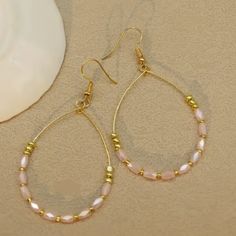 Light Pink Teardrop Beaded Dangle Earrings Light Pink beads and gold hardware, these hoop dangle earrings offer a sophisticated and versatile addition to any jewelry collection. With a length of approximately 2 inches long , these earrings are both elegant and understated. Gold Teardrop Beaded Hoop Earrings, Gold Hoop Earrings With Faceted Beads, Gold Beaded Teardrop Dangle Earrings, Elegant Hoop Earrings With Faceted Beads, Elegant Gold Hoop Earrings With Faceted Beads, Gold Beaded Dangle Teardrop Earrings, Elegant Faceted Beads Dangle Hoop Earrings, Elegant Beaded Teardrop Hoop Earrings, Gold Teardrop Hoop Earrings With Dangling Beads