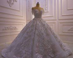 a white wedding dress on display in a room