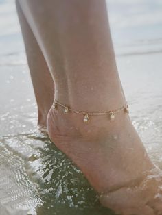 14 karat gold plated anklet featuring tiny shells with pearl beads. Choose your preferred length from the box. Gold Anklets With Pearl Charm As Gift, Gold Anklets With Pearl Charm For Gift, Gold Dainty Anklets With Pearl Charm, Dainty Gold Anklets With Pearl Charm, Dainty Gold Anklets With Pearl Chain, Gold Anklets With Beads For Summer, Gold Anklets With Tiny Beads As Gift, Gold Jewelry With Tiny Beads For Summer, Summer Gold Jewelry With Tiny Beads