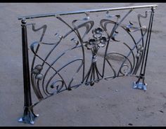 an iron gate with decorative designs on it