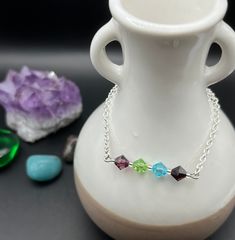 This bracelet is made using sterling silver plated chain and secured with a ball and joint clasp. The gemstones on the bracelet are 6mm Amethyst, Peridot, Aquamarine and Garnet.  How these gemstones support us when grieving:  Amethyst - promotes peacefulness and helps heal personal losses.  Peridot - reduces stress, anger and guilt and opens the heart to bring in joy. Aquamarine - is a powerful healing stone, encourages positive energy and restores balance.  Garnet - purifies and balances energy, while encouraging hope and strength in a seemingly hopeless time.  Bracelet length (current): 7 inches * The bracelet length can be adjusted upon request, please message me for more information (add the personalization and put the length you wish this to be in the message) If you need the length a Silver Crystal Birthstone Bracelet With Spiritual Style, Silver Spiritual Crystal Bracelet With Birthstone, Spiritual Silver Crystal Bracelet With Birthstone, Sterling Silver Birthstone Bracelets With Round Beads, Sterling Silver Crystal Bracelet With Faceted Beads For Gift, Hypoallergenic Sterling Silver Crystal Bracelet Gift, Spiritual Sterling Silver Beaded Bracelets With Birthstone, Silver Birthstone Crystal Bracelet For Jewelry Making, Sterling Silver Faceted Crystal Bracelet Gift