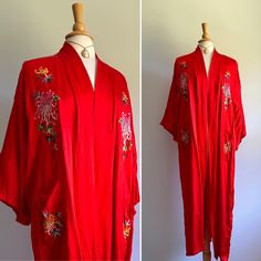 This stunning kimono features an intense shade of cherry red with traditional floral embroidery in hues of pink, green, yellow and blue. Unlined. Fits up to large sizes.  Label: none  Era: early 2000s  Pictured on a US size 6/8 dress form  Two hip pockets  Clean and ready to wear  Minor scuff on lapel (see photo) Spring Floral Embroidered Kimono With Kimono Sleeves, Spring Floral Embroidery Kimono With Kimono Sleeves, Long Floral Embroidery Kimono For Festivals, Long Floral Embroidered Kimono For Spring, Long Floral Embroidered Kimono For Festival, Spring Long Silk Kimono, Spring Silk Long Kimono, Long Silk Kimono For Spring, Red Bohemian Robe With Kimono Sleeves