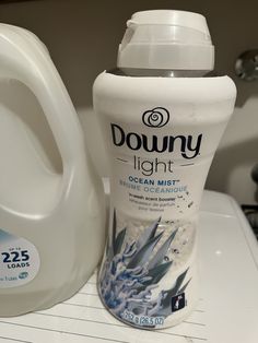 a bottle of downy light next to a gallon of ocean mist