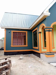 a blue house with orange trim around the windows