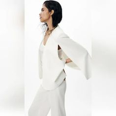 V-Neck Jacket With Long Cape Sleeves With Slits. Tonal Interior Viscose Lining Ecru Chic V-neck Evening Outerwear, Winter White V-neck Outerwear For Spring, Elegant V-neck Evening Outerwear, V-neck Winter White Outerwear For Spring, Spring V-neck Outerwear In Winter White, Elegant Cream Open Front Outerwear, Tailored Elegant V-neck Outerwear, Elegant Open Front Outerwear For Office, Elegant Tailored V-neck Outerwear