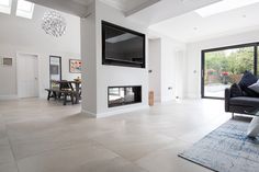 a large living room with a flat screen tv mounted to the side of it's wall