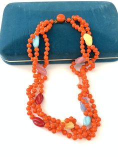 Vintage Colorful Glass Beaded Necklace, Art Deco Orange Glass Multi Color Rainbow Necklace, Bright bold colorful beaded necklaceAmazing vintage new old stock Art Deco 1930s Czech glass beaded orange necklace with multi color twist beads. The necklace is in good antique condition, they are new old stock and were found in their original form so some might be a bit dusty but they are in overall good antique condition. The orange is bright and beautiful and a very unique shade from what I have seen. Vintage Glass Beaded Necklaces With Colorful Beads, Vintage Orange Necklace With Colorful Beads, Vintage Orange Beaded Chain Jewelry, Retro Beaded Necklace With Colorful Round Beads, Orange Glass Beaded Jewelry, Retro Beaded Necklaces For Jewelry Making, Retro Orange Necklace Gift, Vintage Orange Oval Beads Jewelry, Vintage Orange Jewelry With Faceted Beads