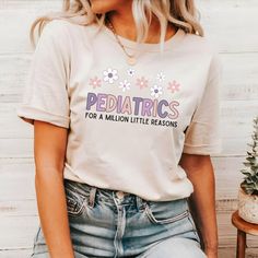 a woman wearing a tee shirt that says pediatrics for a million little reasons