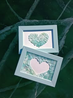 two framed pictures with hearts on them sitting next to each other