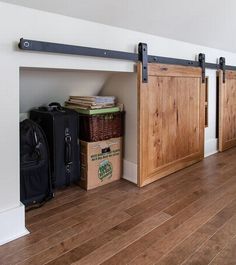 an empty room with several wooden doors and luggage on the floor next to each other