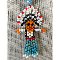 Native Needlepoint Boy Seed Bead Necklace -- 18". In New Condition. This Necklace Is Bright And Lightweight And Easy To Wear On A Beaded Necklace. A Native Boy With Long Black Hair And Blue Pants. Measurements: Length: 18"; Pendant: 2"X1". Artisan White Dangling Beads, Traditional White Beads For Crafting, White Beaded Dangle Necklaces, White Beaded Dangle Necklace, White Bohemian Beaded Pendant Necklaces, Artisan White Beaded Necklaces With Round Beads, White Artisan Beaded Necklace With Tiny Beads, Artisan White Beaded Necklace With Colorful Beads, Artisan White Beaded Necklace With Round Beads