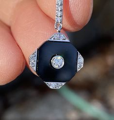 Fourteen karat white gold Art Deco onyx and diamond pendant is set with 17 round brilliant cut diamonds totaling.17ct VS clarity E-F color and a custom cut onyx stone. Available is all karats and colors of gold and platinum, inquire for prices. 35mm top to bottom, 14mm wide. Money back guarantee within 14days. Buyer pays return shipping and must be returned in original condition with box and no alterations. Black Platinum Jewelry For Anniversary, Black Diamond Necklaces, Black Platinum Jewelry With Polished Finish, Art Deco Style Single Cut Diamond Pendant, Black Cubic Zirconia Jewelry With Polished Finish, White Gold Diamond Jewelry With Black Enamel, Black Platinum Jewelry With Diamond Accents, Black Diamond Necklace With Diamond Accents, Black Diamond Necklace With Round Diamond Accents