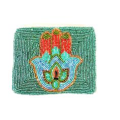 a small beaded purse with an ornate design on the front and side, in green