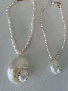 Turbo shell necklaces. Order one on a dainty av chain or email us to make a custom one with fun beads. Luxury Handmade Elegant Shell Necklace, Luxury Beaded Shell Necklace As Gift, Cheap Shell Necklaces With Round Beads, Cheap Silver Shell Necklace, Big Shell Necklace, Jewelry With Pearls, Hawaii Crafts, Big Pearl Necklace, Treasure Beach