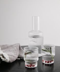 three clear glass cups sitting on top of a table