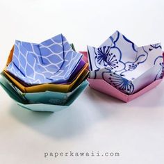 three paper bowls are stacked on top of each other, one is blue and the other is pink