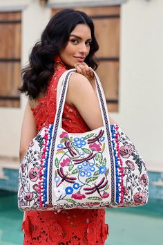 Multi-purpose tote Comfortable double shoulder straps Embellished front Pompom lace detail Embroidered lace detail on the straps Magnetic button closure Made in hand-woven jacquard Fully lined interiors with zip pocket and a mobile pocket Size: 24" x 13" x 6" Step into a world of enchantment with the Dragonfly Dreams Kashmiri Tote, where every stitch tells a story of elegance and craftsmanship. Inspired by the ethereal beauty of dragonflies dancing over tranquil waters, this tote is creative and Embroidered Shoulder Bag For Travel In Spring, Spring Embroidered Shoulder Bag For Travel, Spring Travel Shoulder Bag With Embroidery, Spring Embellished Bags For Everyday Use, Spring Embellished Bags For Everyday, Bohemian Embellished Bag For Vacation, Bohemian Embellished Bags For Vacation, Cotton Crochet Travel Bag, Bohemian Beige Shoulder Bag With Floral Embroidery