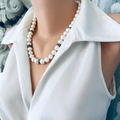 Add an elegant touch to any outfit with this Classic White Pearls Necklace. Crafted with exquisite attention to detail, this necklace features zircons pave rondelles for a stunning sparkle. The gunmetal plated and sterling silver materials lend a classy and timeless touch to this piece. Perfect as a Mother's Day gift or for a bride on her special day, this necklace is 20 inches in length and exudes sophistication and beauty. Complete your look with this exquisite piece of bridal jewelry and make Elegant Pearl White Jewelry With Gemstone Beads, Classic Beaded Necklaces With Gemstone Beads, Elegant Pearl White Jewelry With Natural Stones, Formal Necklaces With Round Beads And Stones, Formal Necklace With Round Beads And Stones, Elegant Pearl Necklace With Gemstone Beads, Elegant Pearl White Necklace With Faceted Beads, Elegant Pearl Necklace With Stones, Elegant Bridal Necklace With Faceted Beads For Formal Occasions