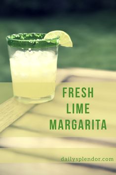 a glass filled with lemonade sitting on top of a wooden table