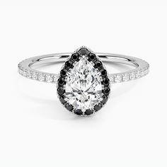 a pear shaped diamond ring with black and white diamonds