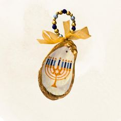 an image of a hanukkah ornament hanging from a beaded necklace