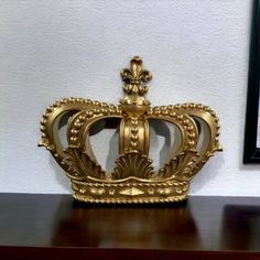 a gold crown sitting on top of a wooden table