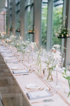 the long table is set with flowers and candles