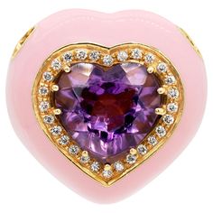 This gorgeous 18 carat yellow gold pendant is beautifully designed as a 3D heart with an open work flat back. A heart shaped amethyst, weighing approximately 5.00ct, is beautifully set in the centre in a nine claw setting. The vibrant amethyst is highlighted by 28 fine quality round brilliant cut diamonds, weighing approximately 0.30ct combined, giving a beautiful contrast. Finally, the lovely piece is bordered with glossy pink enamel. Stamped THE PEARL GALLERY, Italy, circa 1990's. Yellow Heart Cut Fine Jewelry, Luxury Heart-shaped Enamel Jewelry, Fine Jewelry Heart-shaped Amethyst, Luxury Yellow Heart-shaped Jewelry, Heart-shaped Pink Sapphire Jewelry For Gift, Glossier Pink, 3d Heart, Heart Pendant Gold, Pink Enamel