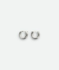 "Find BOTTEGA VENETA Watch Hoop Earrings on Editorialist. Sterling silver earrings. Hinged closure. External dimensions: 15 mm | 0.59\". Width: 10 mm | 0.39\". Thickness: 3.7 mm | 0.14\". Color: Silver. Due to hygiene-related reasons, this piece may not be returned. • Material: Sterling Silver." Silver Timeless Hoop Earrings, Timeless Silver Drop Hoop Earrings, Timeless Silver Tarnish Resistant Hoop Earrings, Classic White Gold Metal Earrings, Luxury Silver Tarnish-resistant Huggie Earrings, White Gold Round Huggie Earrings, Timeless Silver Small Hoop Jewelry, Luxury Silver Huggie Earrings With Polished Finish, Timeless Round Huggie Earrings With Polished Finish