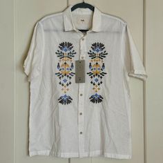 Folk Clothing Short Sleeve Button Up Shirt Condition: Excellent, New With Tags Color: White With Multicolored Embroidery Style: Mast Size: Medium Measurements: Chest (Armpit To Armpit): 22 Length: 28 In. Sleeve Length: 10 In. Details: Fabric Has A Soft And Has A Linen-Like Feel White Shirt With Button Closure For Summer, Casual Embroidered Collared Shirt, White Button-closure Shirt For Vacation, White Summer Shirt With Buttons, White Shirt With Button Closure For Vacation, White Button Shirt For Summer, Relaxed Fit Floral Embroidery Shirt For Vacation, Embroidered Tops With Relaxed Fit, White Vacation Top With Placket