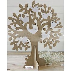 a wooden tree with white birds on it