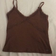 Hollister Size Medium Never Worn It’s Brown And Very Cute Casual Cami Tops For Fall, Fitted Cami Tops For Fall, Trendy Brown Camisole Top, Fitted Camisole Tops For Fall, Brown Cami Top For Spring, Trendy Brown Cami Top, Casual Brown Camisole Top, Casual Brown Camisole, Fitted Brown Top With Lace Trim