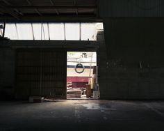 an open garage door with a clock hanging from the ceiling