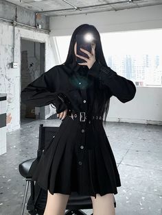 This Gothic Pleated Shirt Dress is a striking ensemble that marries tailored elegance with a touch of subculture flair. The crisp collar and button-down front give it a classic shirt-style look, while full-length sleeves with buckle details inject a modern twist. A fitted waist cinched by a belt adorned with metallic grommets transitions into a sharply pleated skirt, creating a silhouette that is both sophisticated and edgy. The chain accessory attached to the belt provides a nod to gothic sensi Unique Clothing Stores, Bow Crop Tops, Techwear Fashion, Pleated Shirt Dress, Tunic Designs, Collared Top, Pleated Shirt, The Gothic, Korean Dress