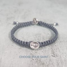 "This hand-woven bracelet features a 1cm silver tone medal charm in the center and a small St Benedict medal on top of the clasp. Design your own bracelet and we will make it for you. Choose Saint Medal and Cord color for your bracelet and it will be made just for you. You can choose from different medals of saints and cord colors. (SEE PHOTOS 4,5,6) Hand woven in Medjugorje. Medals made in Italy. This unique bracelet comes on string with a sliding slipknot for an easy fit. 9.5 \"(24cm) when ful Adjustable Miraculous Medal For Gift, Silver Spiritual Rosary Bracelet For Blessing, Adjustable Hypoallergenic Silver Rosary Bracelet, Silver Spiritual Bracelets For First Communion, Silver Spiritual Bracelet For First Communion, Adjustable Spiritual Bracelets With Miraculous Medal, Personalized Adjustable Silver Rosary Bracelet, Handmade Silver Bracelets For First Communion, Handmade Adjustable Rosary Bracelet For First Communion