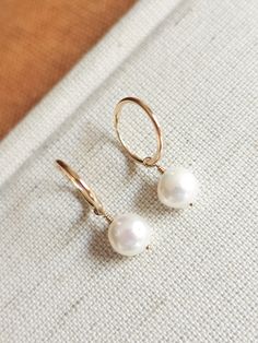 These dainty freshwater pearl hoops are the perfect accessory to complete that minimalist modern look! Great to give as a gift or to treat yourself! --------------------------- D E T A I L S * Earrings are made out of 14k gold-fill wire - Great for those sensitive to specific metals - Lightweight for easy wear * Hand-shaped rounded wire (14mm in diameter - 1.20mm thick) * Pearls measure 8mm * Ethical sourcing of all materials * Packaged neatly + securely in a reusable drawstring bag - ready to g Minimalist Hoop Pearl Charm Jewelry, Minimalist Hoop Jewelry With Pearl Charm, Minimalist 14k Gold-filled Hoop Earrings With Pearl Charm, Minimalist Pearl Charm Hoop Earrings For Everyday, Minimalist Pearl Hoop Earrings Hypoallergenic, Minimalist Everyday Hoop Earrings With Pearl Charm, Minimalist 14k Gold Filled Huggie Earrings With Pearl Charm, Small Pearl Hoop Earrings For Everyday, Everyday Hoop Pearl Earrings With Ear Wire