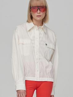 Editor's Notes Soft and drapery, this loose fitting, blouson-style shirt has classic open collar and snap button fastenings. It is accentuated with color trimmed stitch detail throughout. - Cotton and nylon blend fabric- Natural, relaxed silhouette- Wide chest pockets with rubber patch detail- Banded detail at hem for flexible fitMeasurements(in.)Size One Size(XS-M)- Shoulder: 20.51 in - Bust: 24.49 in - Armhole: 11.89 in - Sleeve width: 11.61 in - Sleeve length: 22.87 in - Length: 25.75 in * Model info: Height 5' 10 Bust 32 Waist 23 Hip 34.5Composition & Care- 73% Cotton, 27% Nylon - Dry Cleaning only Designer- by EN OR White Lapel Collar Blouse With Placket, White Blouse With Lapel Collar And Placket, White Shirt With Hidden Button Closure For Spring, White Tops With Lapel Collar And Concealed Placket, Spring Top With Lapel Collar And Concealed Placket, Spring Top With Concealed Placket And Lapel Collar, Cream Spread Collar Tops For Workwear, White Blouse With Concealed Placket For Spring, Spring Collared Tops With Concealed Placket