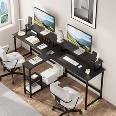 a computer desk with two monitors on top of it next to a chair and table